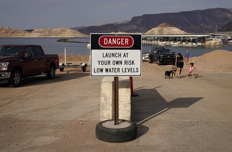 Sign at a boat ramp on Lake Mead, near Boulder City, Nevada, Aug. 13, 2021. The lake currently is roughly two-thirds empty. AP Photo/John Locher