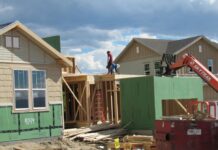 Construction workers build a single family home in Castle Rock photo